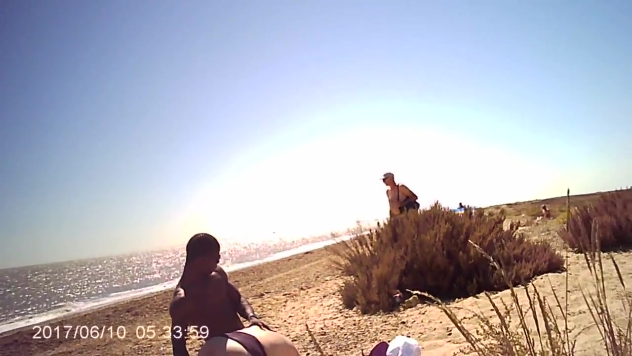 swingers on beach with watchers