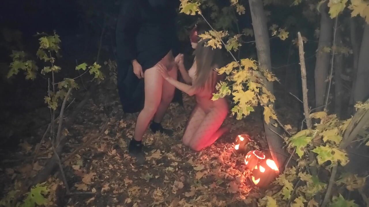 Amateur couple makes sexual intercourse in the woods on the Halloween image image