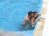 Sexually Aroused couple makes sexual intercourse in public swimming pool while hidden voyeur records